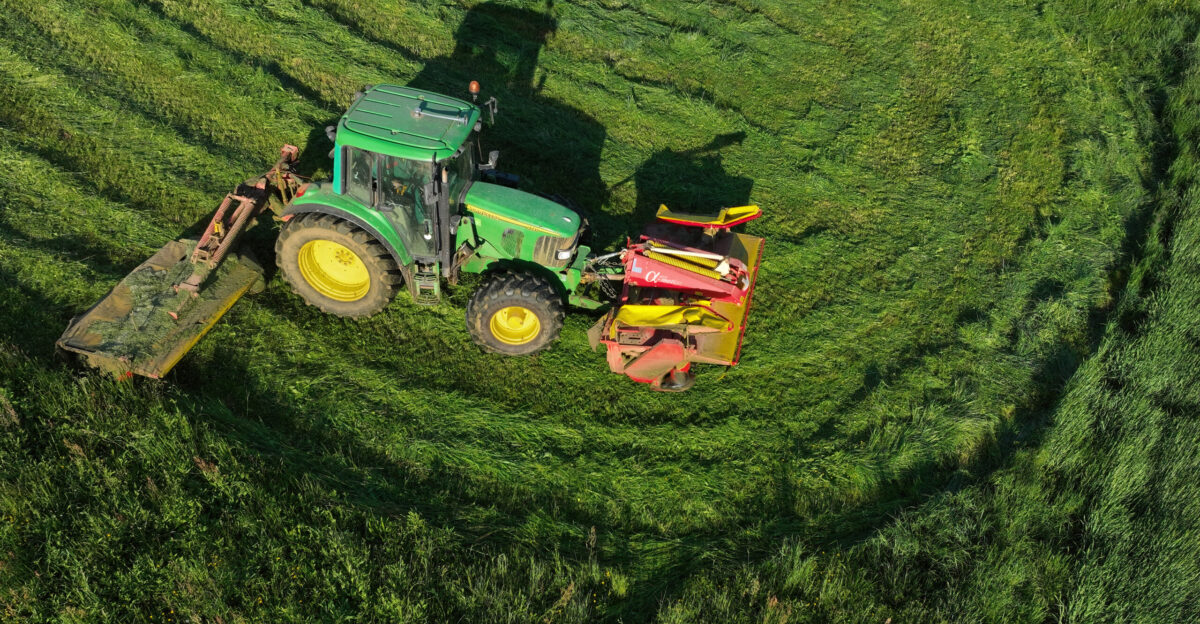 Tractor John Deere 6320 with front and rear mower cutting grass near Sti na a village in the Municipality of Ivan na Gorica southeastern Slovenia