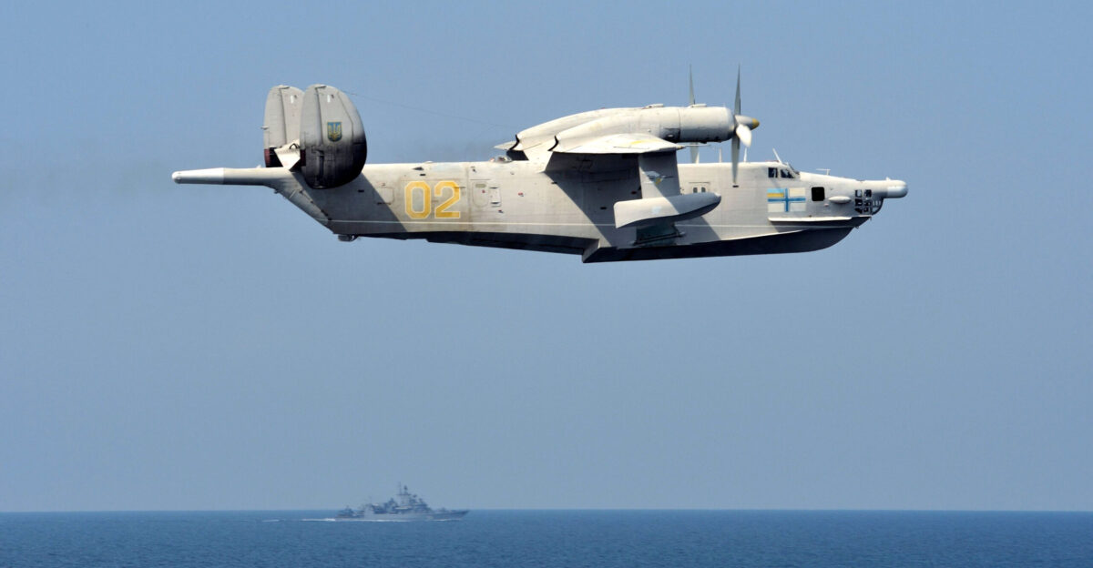 A Ukrainian navy Beriev Be-12 in flight over the Black Sea during exercise Sea Breeze 2014 In the background is the frigate Hetman Sahaidachnyi U130