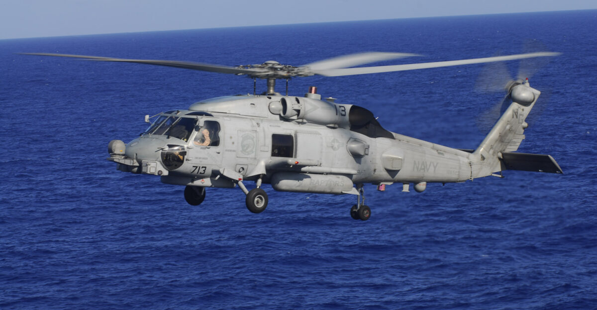 PACIFIC OCEAN May 19 2009 An MH-60R Sea Hawk helicopter from the Raptors of Helicopter Maritime Strike Squadron HSM 71 flies alongside the aircraft carrier USS John C Stennis CVN 74 during flight operations John C Stennis and Carrier Air Wing CVW 9 are on a scheduled six-month deployment to the western Pacific Ocean U S Navy photo by Mass Communication Specialist 3rd Class Kenneth Abbate Released