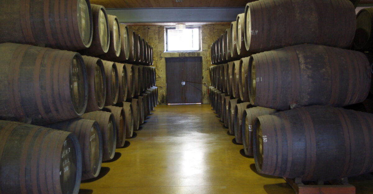 While Port wine takes its name from the city of Porto also spelled Oporto all Port Wine actually comes from Vila Nova de Gaia or the New Town of Gaia which was established by Alfonso III in 1253 due to a disagreement with the Bishop of Oporto over duties on shipping When the Port Wine trade developed in the 17th century it was centered around Vila Nova de Gaia and for most of the history of Port Wine it has only been legally possible to sell it from Vila Nova de Gaia These barrels are in the 18th century warehouse of Vasconcellos Port cellars where we tried 10-Year 20-Year 40-Year and 1902 Vintage Port in addition to some young white Port