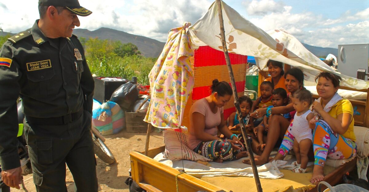 Colombian refugees in a makeshift shelter seeking shade