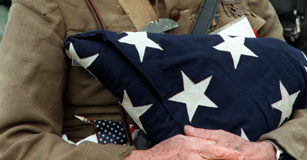 Joseph Ambrose an 86-year-old World War I veteran attends the dedication day parade for the Vietnam Veterans Memorial in 1982 Wearing a doughboy uniform like the ones used during the war he is holding an American flag It covered the casket of his son Clement who was killed in the Korean War