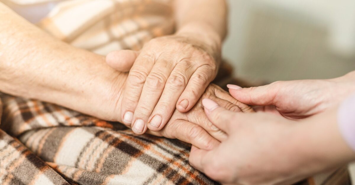 Old and young holding hands Care for the elderly concept