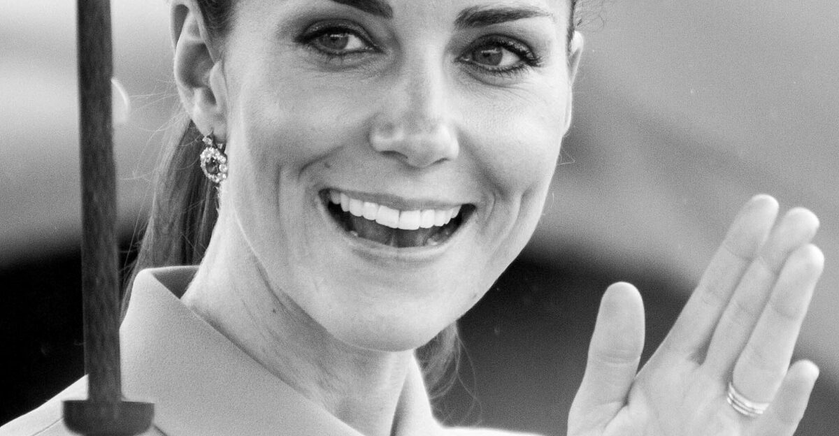 Her Royal Highness The Duchess of Cambridge Countess of Strathearn and Lady Carrickfergus April 2014 The hand holding the umbrella at lower left of the image is that of the Duke of Cambridge the background is a light aeroplane 1