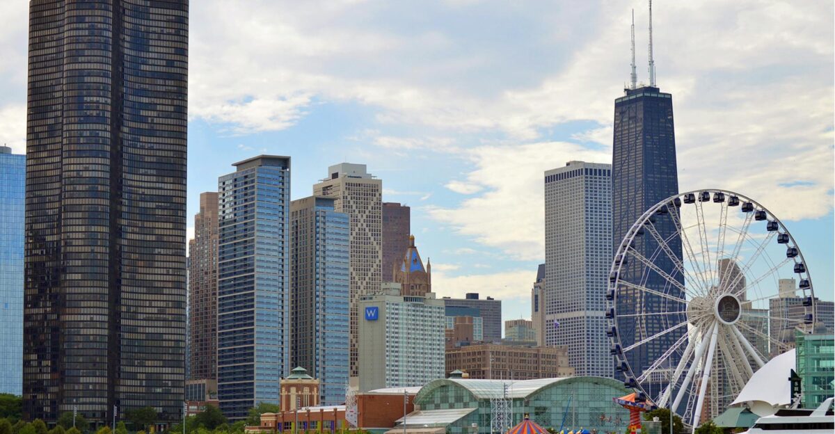 Chicago skyline featuring the iconic Ferris wheel on Navy Pier with skyscrapers like Hancock Tower