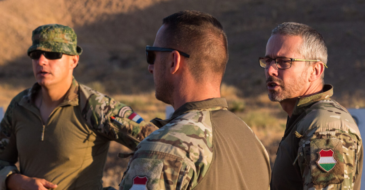 Coalition Forces discuss battle drills to prepare for range operations at Beneslawa Range in Erbil, Iraq, June 20, 2025. Coalition Forces train warfighting skills to maintain lethality and enable regional security and stability. (U.S. Army photo by Master Sgt. Ray Boyington)