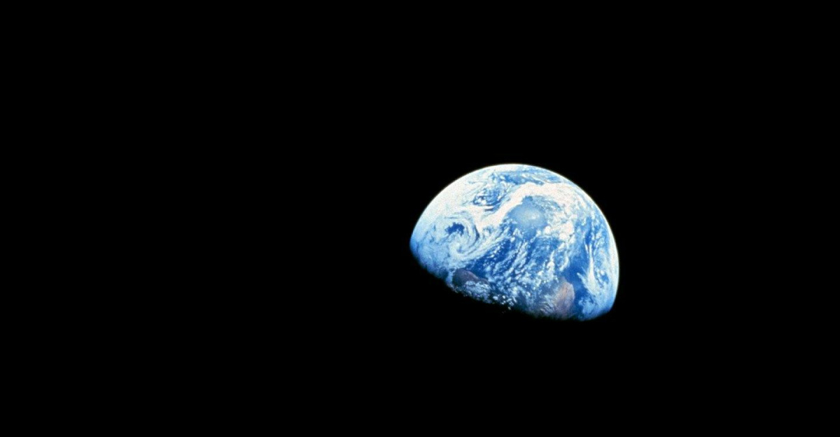 Iconic view of Earth rising over the lunar surface in space, capturing celestial beauty.