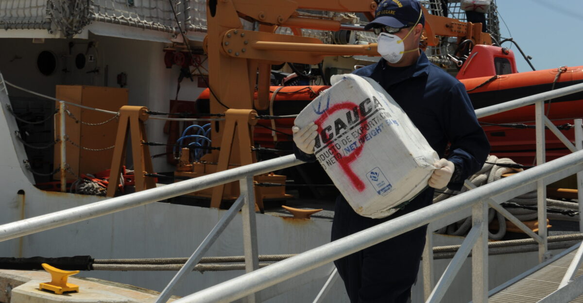 A U S Coast Guardsman unloads a bale of cocaine from the medium endurance cutter USCGC Legare WMEC 912 at Coast Guard Base Miami Beach Fla April 15 2014 The crew of the Legare unloaded 110 million of cocaine that was seized in the Caribbean Sea as part of Operation Martillo a joint interagency and multinational collaborative effort to deny transnational criminal organizations air and maritime access to the littoral regions of the Central American isthmus DoD photo by Petty Officer 3rd Class Mark Barney U S Coast Guard Released