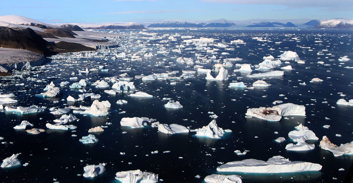 Icebergs are breaking off glaciers at Cape York Greenland The picture was taken from a helicopter