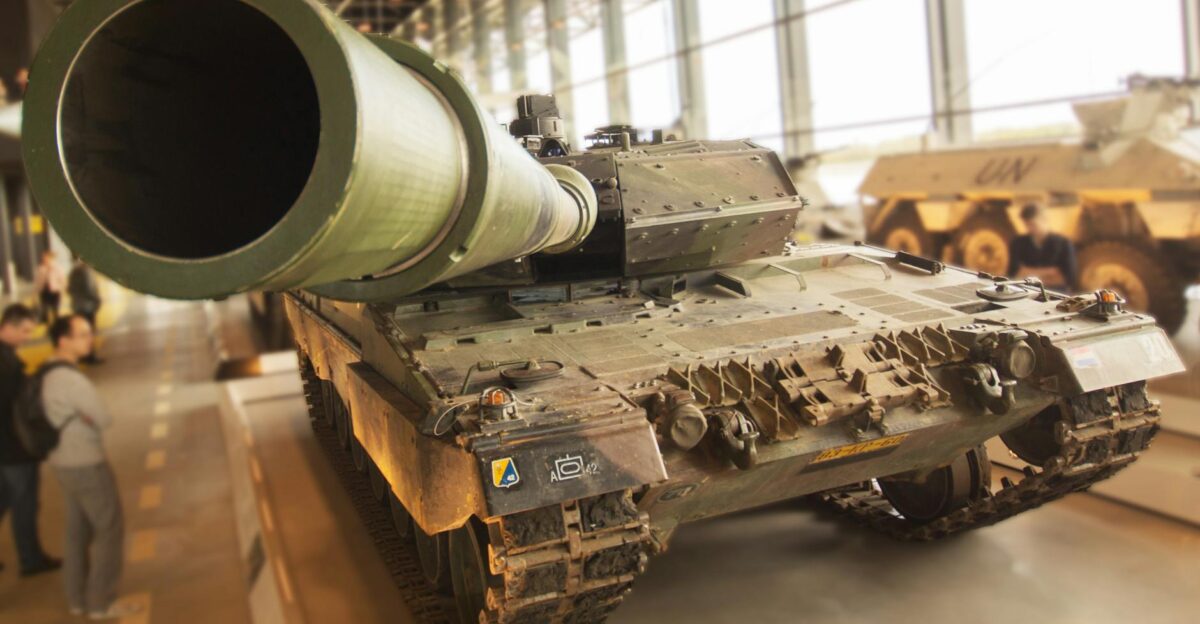 Detailed view of a military tank inside a museum emphasizing the large barrel and robust design