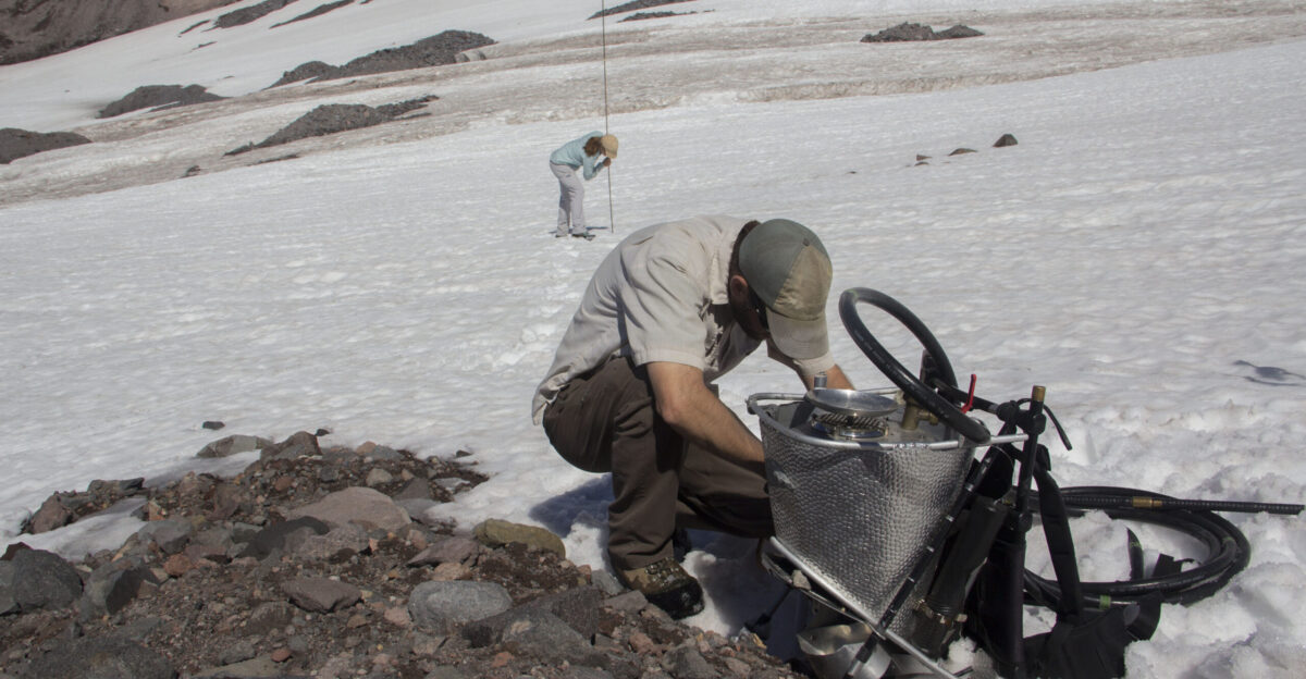NPS employees Rebecca Lofgren L work on steam drill equipment for studying snow depth and snow and ice melt on the Nisqually Glacier NPS photo by Emily Brouwer
