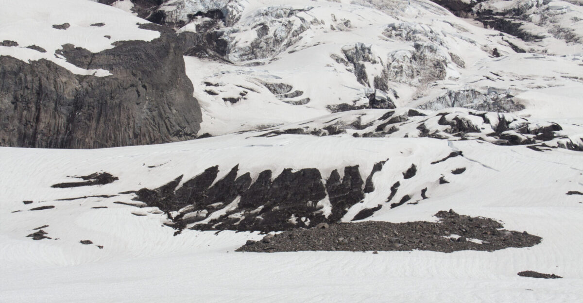 NPS employees Stefan Lofgren L trekking out to equipment for studying snow depth and snow and ice melt on the Nisqually Glacier NPS photo by Emily Brouwer