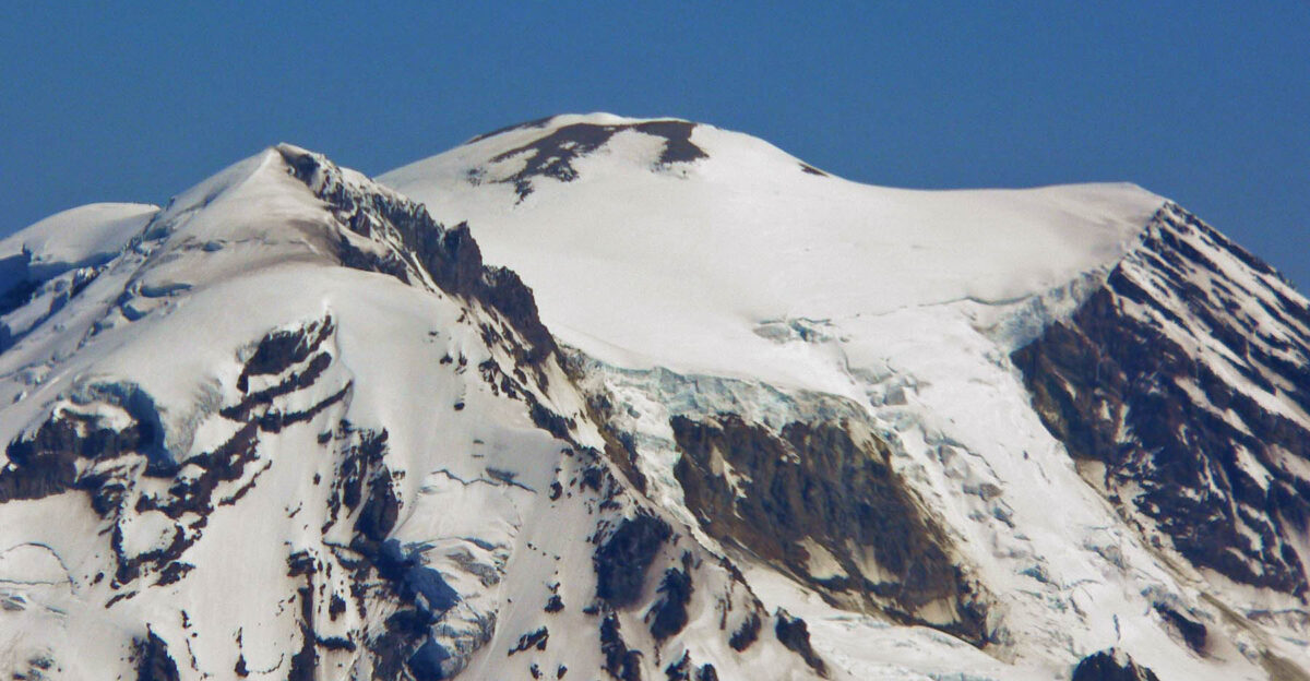 Aerial closeup photo of Mount Rainier summit area taken July 2005 by User Stan Shebs From left to right the high points are Liberty Cap Columbia Crest the summit proper and Point Success Tahoma Glacier descends to the lower right past St Andrews Rock
