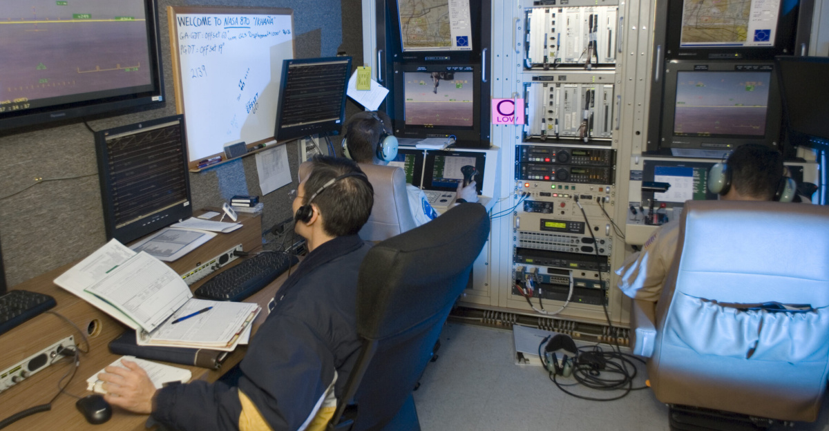 NASA's Ikhana unmanned science aircraft ground control station includes consoles for two pilots and positions for scientists and engineers along the side.