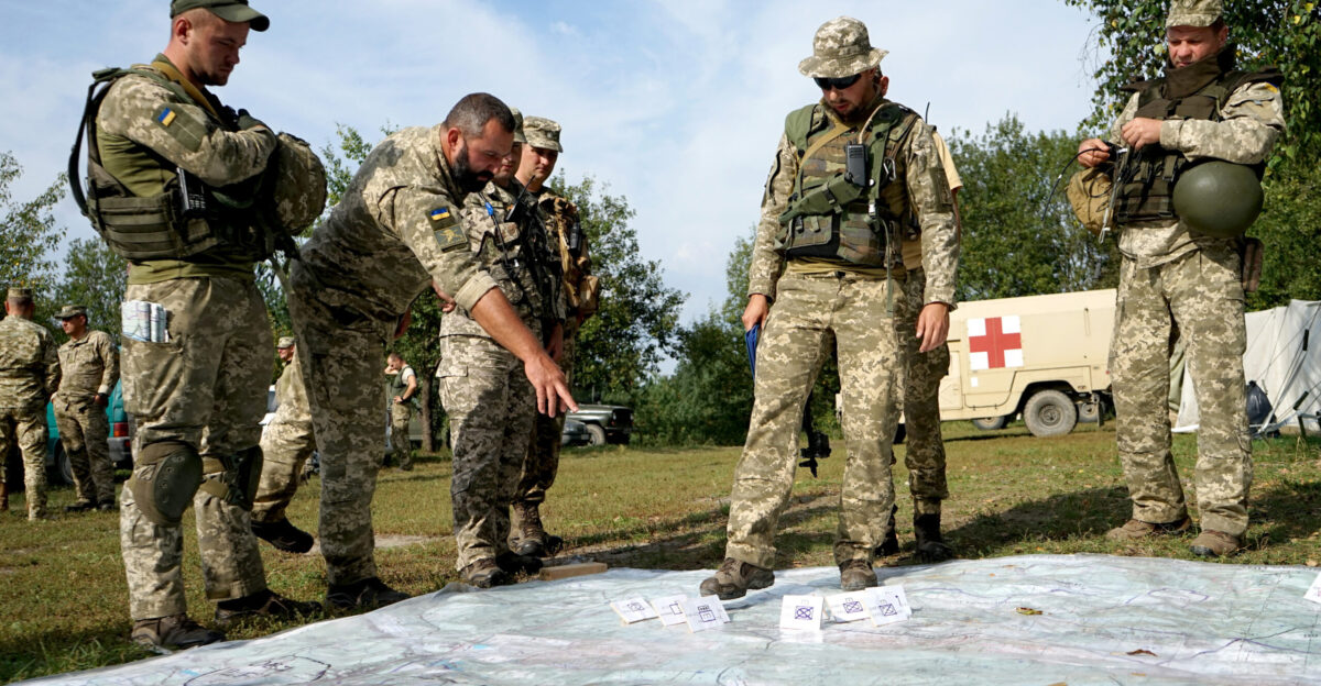 Ukrainian soldiers walk through strategic plans for an exercise during an Operational Capabilities Concept evaluation at the International Peacekeeping and Security Centre in Yavoriv Ukraine Sept 11 2018 The evaluation was being conducted by a multinational OCC evaluation team during the Rapid Trident exercise to assess Ukraine s military interoperability capacity U S Army National Guard photos by Army Spc Amy Carle
