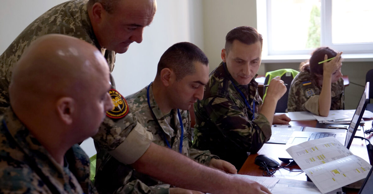 An Operational Capabilities Concept evaluator reviews planning documents with trainees at the International Peacekeeping and Security Centre in Yavoriv Ukraine Sept 10 2018 The trainees were working with certified OCC evaluators to observe exercises and assess interoperability capacity in accordance with NATO standards U S Army National Guard photos by Army Spc Amy Carle