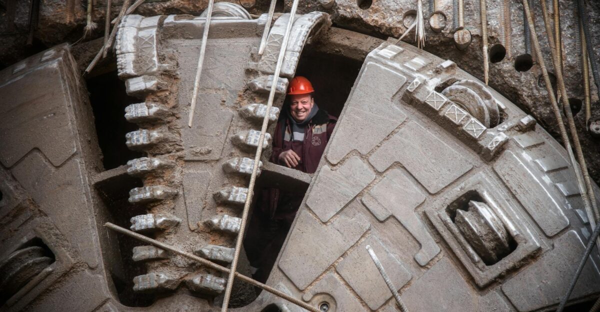 Construction worker stands inside massive tunneling machine in Moscow Russia showcasing industrial capability