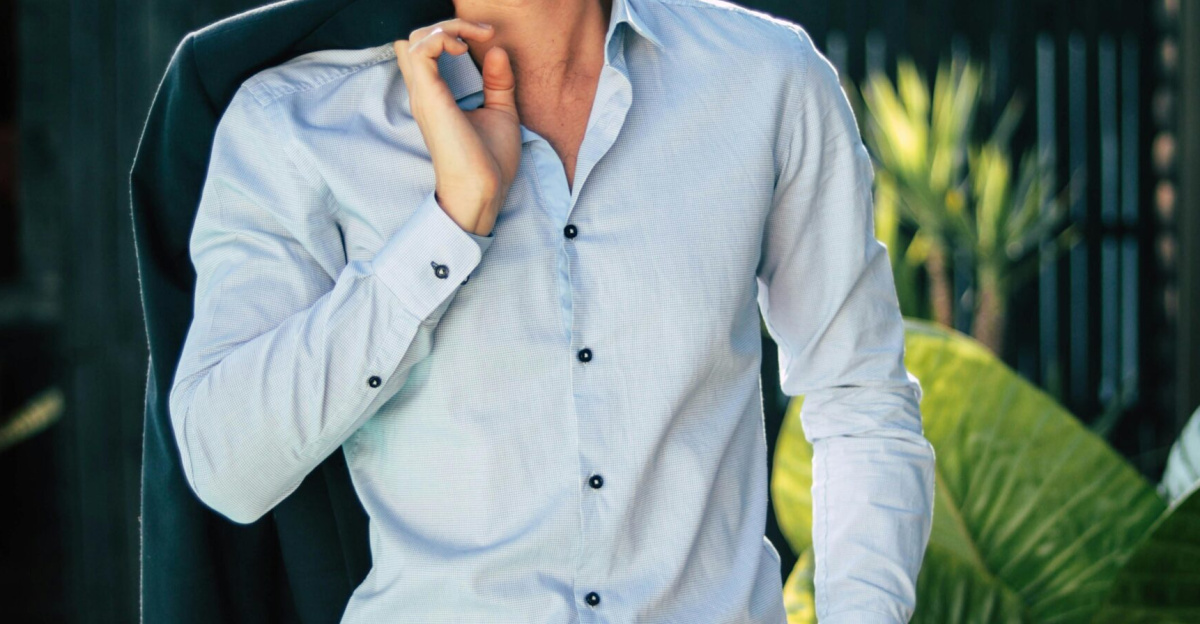 Confident young man in a stylish suit outdoors, exuding charm and elegance.