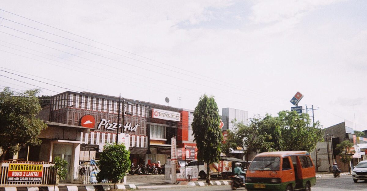 City street with Pizza Hut and Domino s Pizza featuring traffic and signages