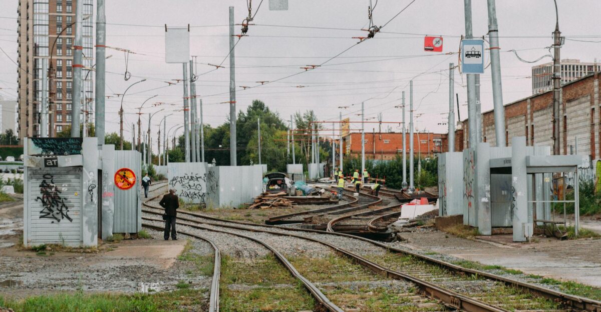 A city railway track area under construction with workers and infrastructure