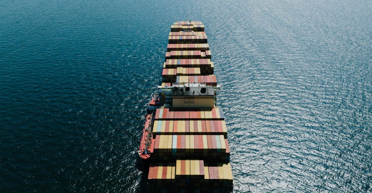 Drone shot of a loaded container ship sailing through the sea near Naples Italy