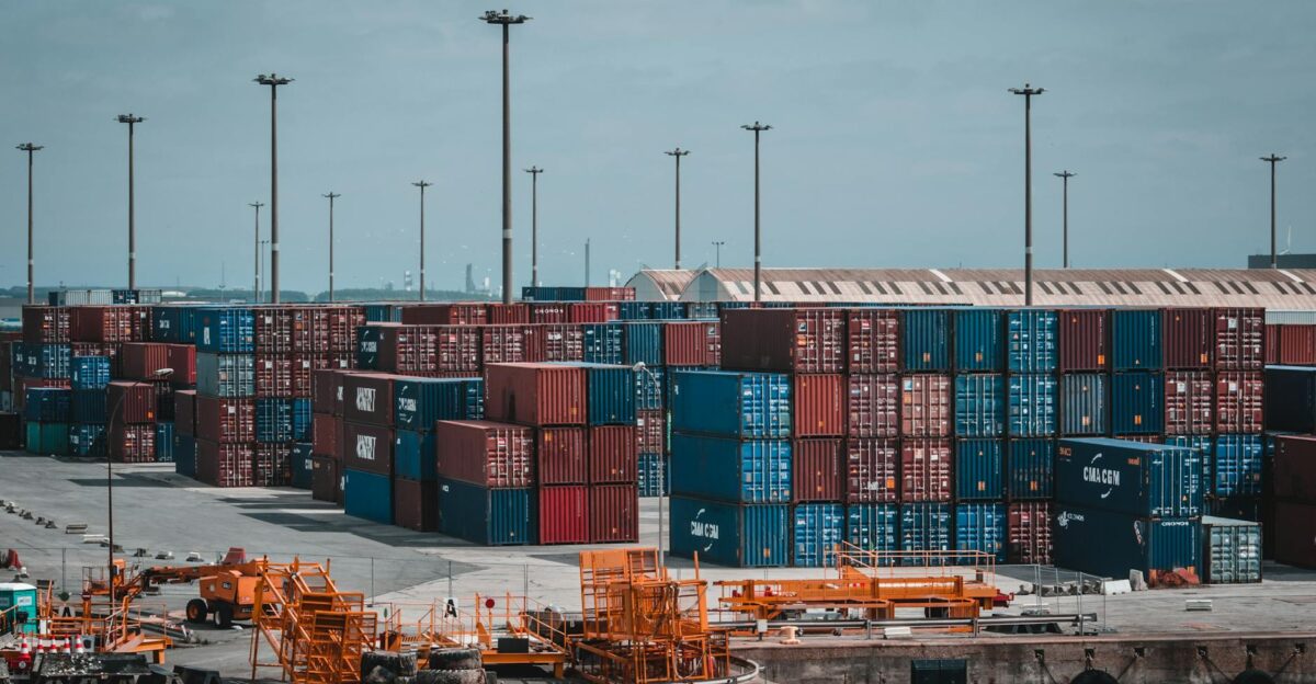 Colorful cargo containers stacked at a busy industrial port showcasing global trade