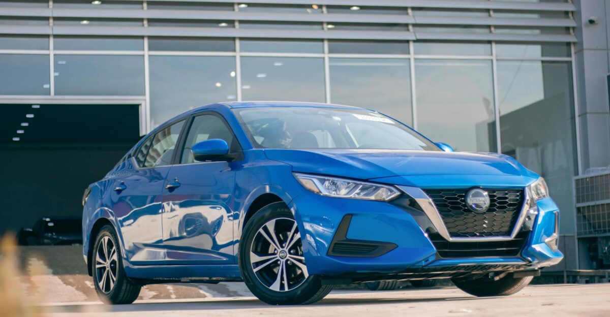 Front view of a modern blue Nissan Sentra parked at a dealership showcasing its sleek design