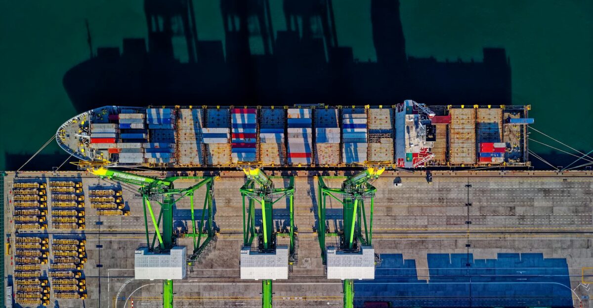 High angle aerial view of a cargo ship at a bustling port in Jakarta showcasing global trade