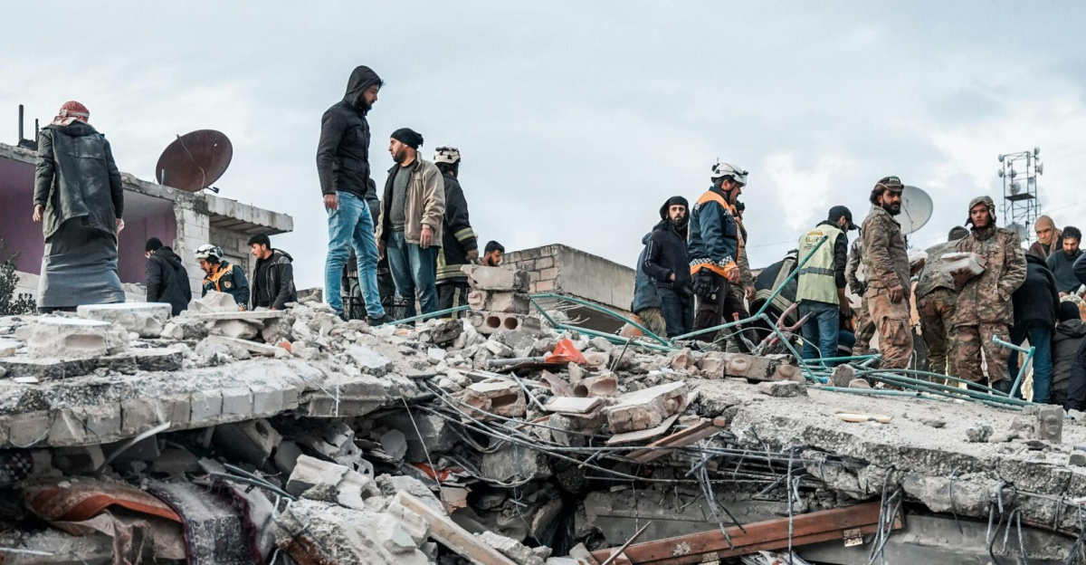 People inspect rubble after an earthquake in Jindires, Aleppo Governorate, Syria.