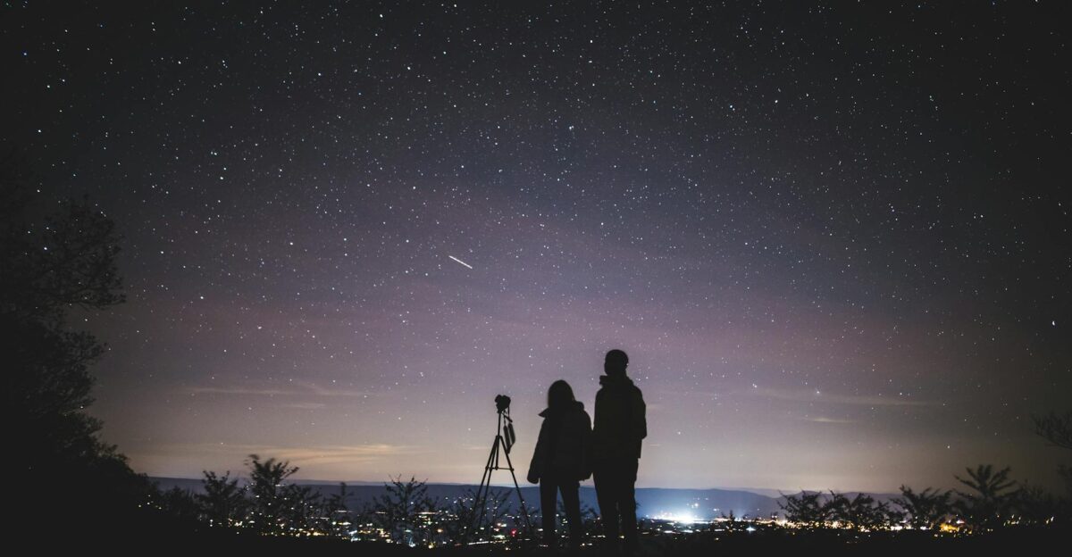 A couple stargazes under a starry sky in Elkton VA capturing the beautiful Milky Way