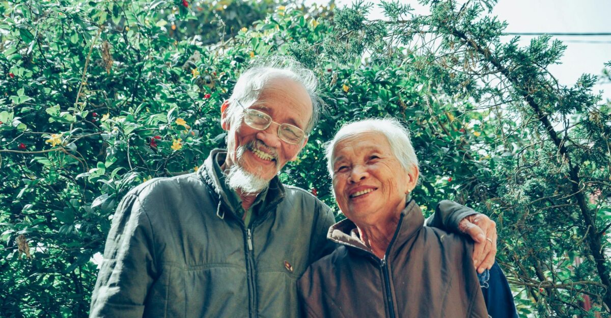 Senior couple enjoying a joyful moment together in a lush garden setting exuding love and happiness