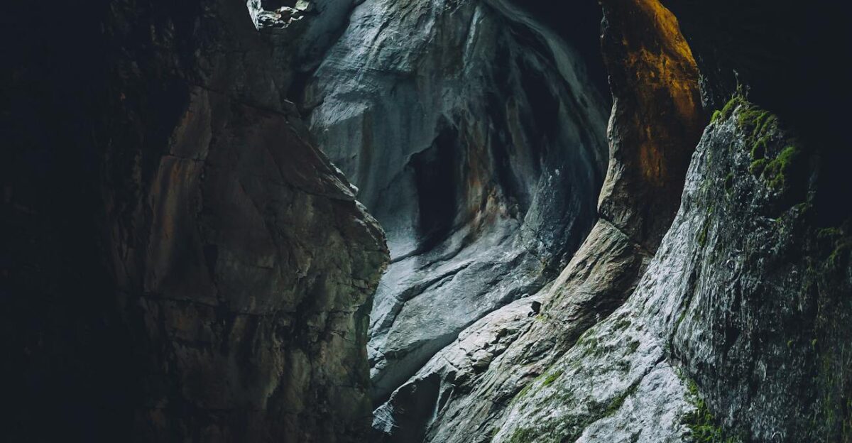 Explore a breathtaking cave with dramatic lighting and geological formations