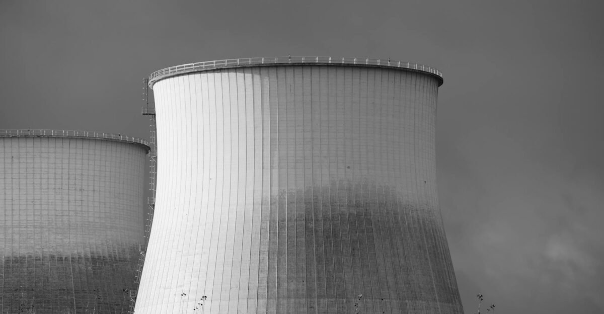 Elegant black and white depiction of cooling towers at a nuclear power station symbolizing energy and industry