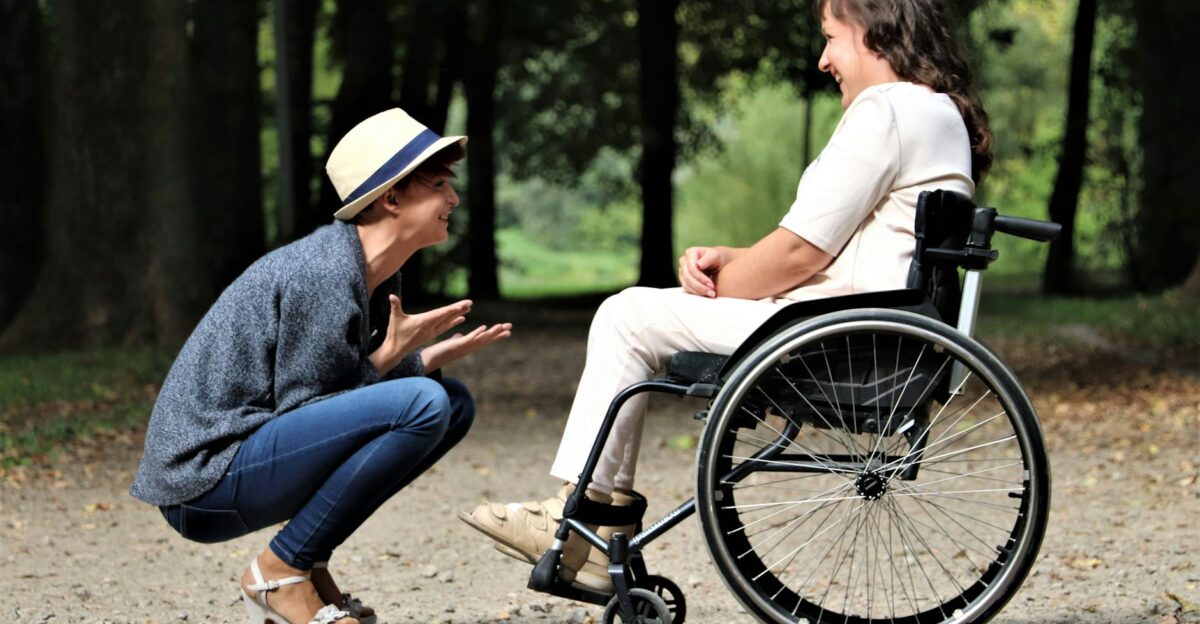 Two women enjoy a lively conversation in a sunny park embracing friendship and happiness