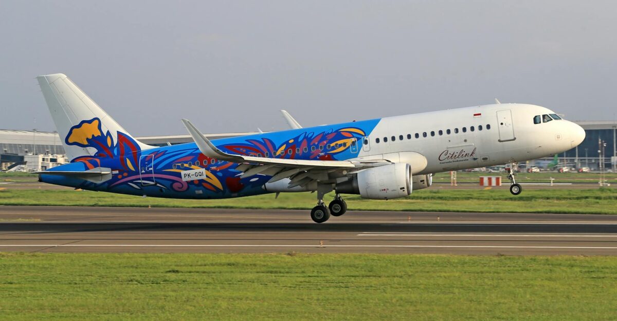 Airbus A320 in colorful Citilink retro livery taking off from airport runway