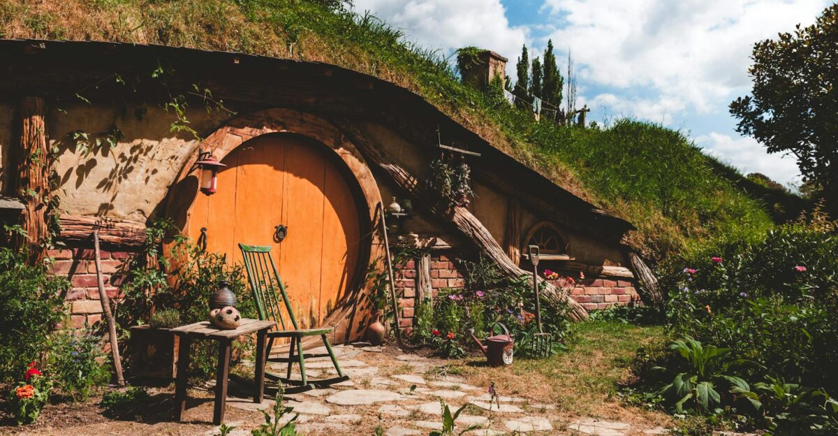 Explore a cozy hobbit house nestled in New Zealand s lush countryside perfect for a rustic getaway