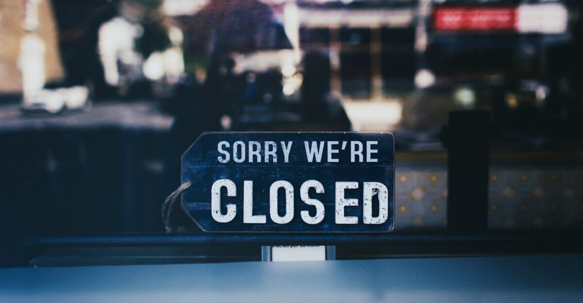 Moody image capturing a Sorry We re Closed sign in a London shop window