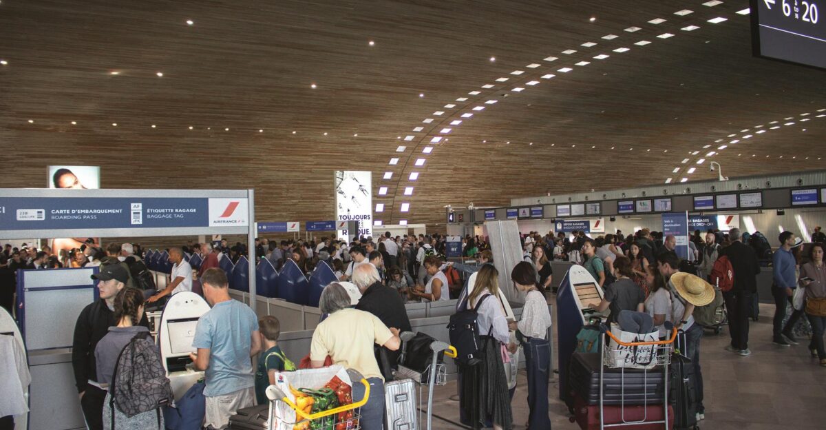 Crowded airport terminal with travellers in line Indoor setting with modern architecture