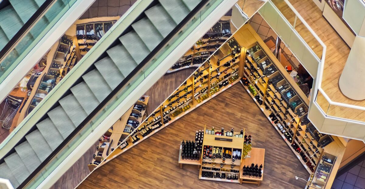 Aerial view of a stylish shopping mall showcasing escalators and well-organized retail displays