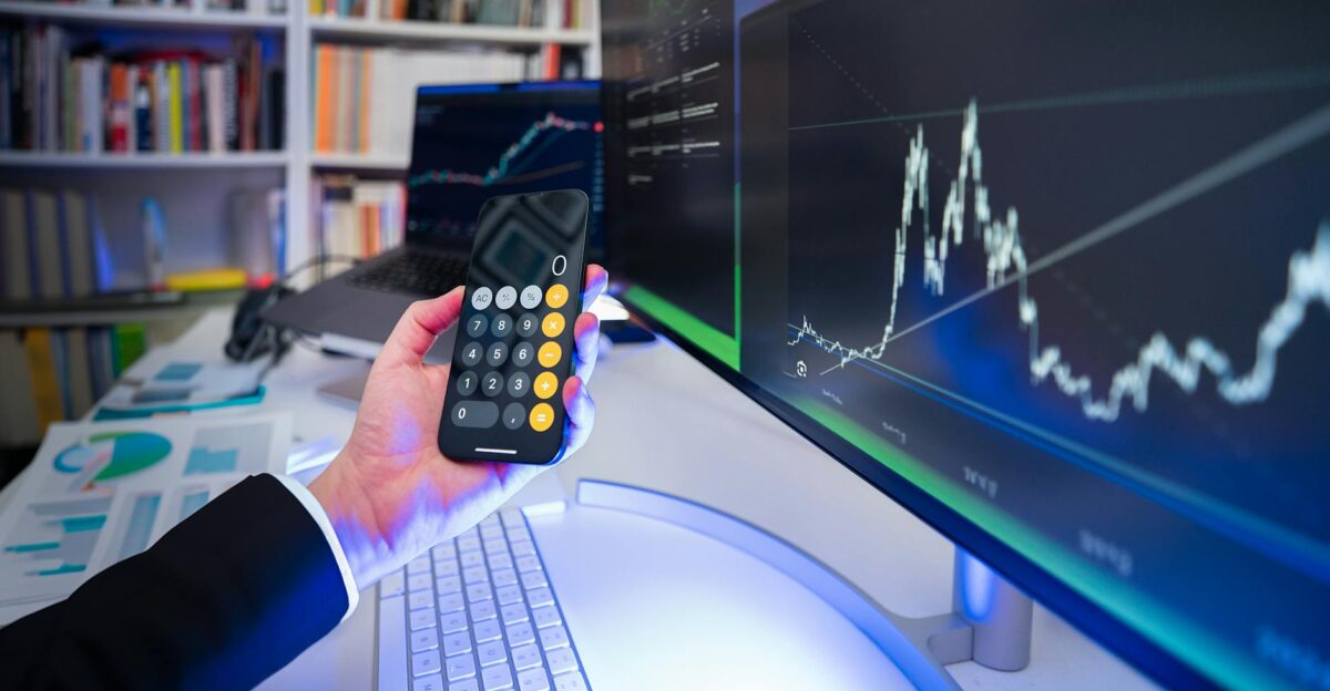 A modern office desk setup with financial analysis tools highlighting technology in business strategy