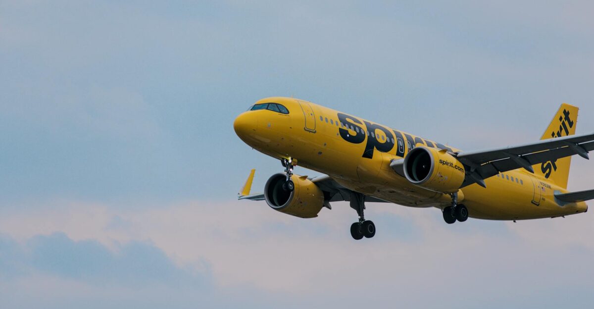 A Spirit Airlines yellow jet in flight over Atlanta showcasing aviation and travel