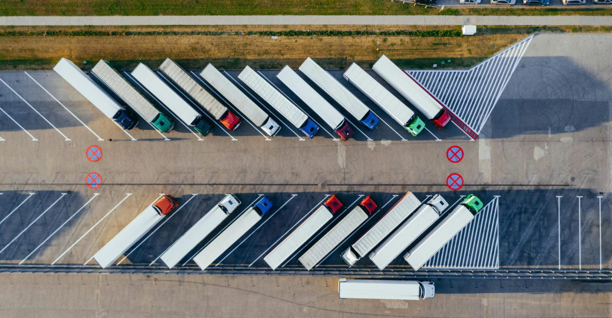 Overhead shot of semi-trucks parked in Poznań, Poland, demonstrating transportation logistics.