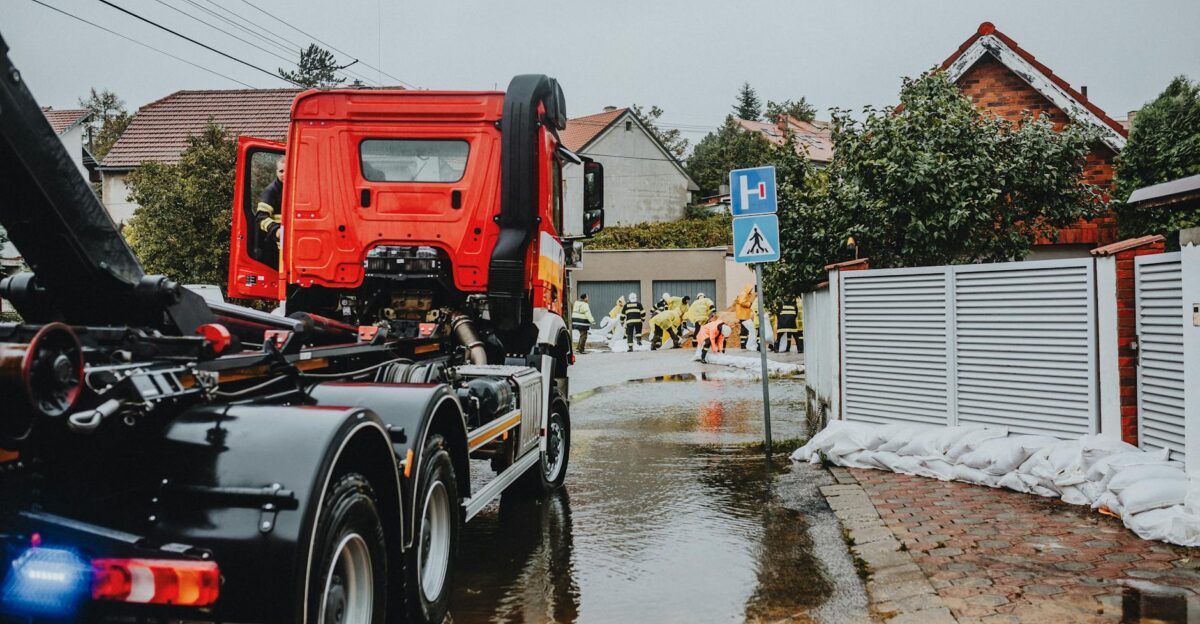 Emergency vehicles and personnel addressing urban flooding caused by heavy rains