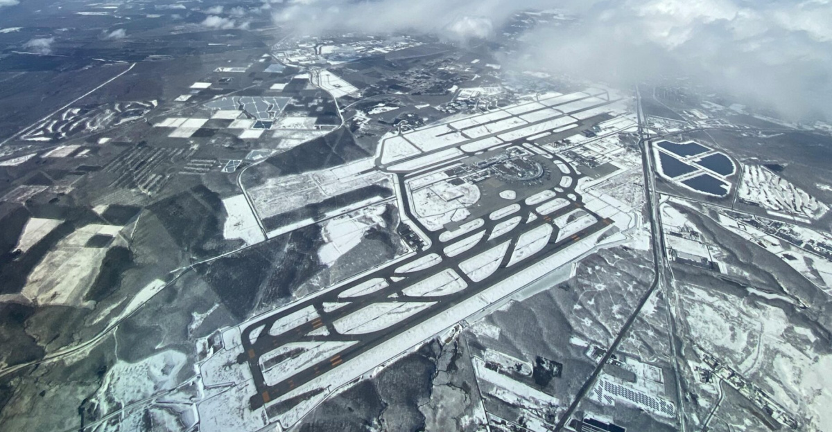 Stunning aerial shot of a snow-covered landscape in Chitose, Hokkaido under a clear blue sky.