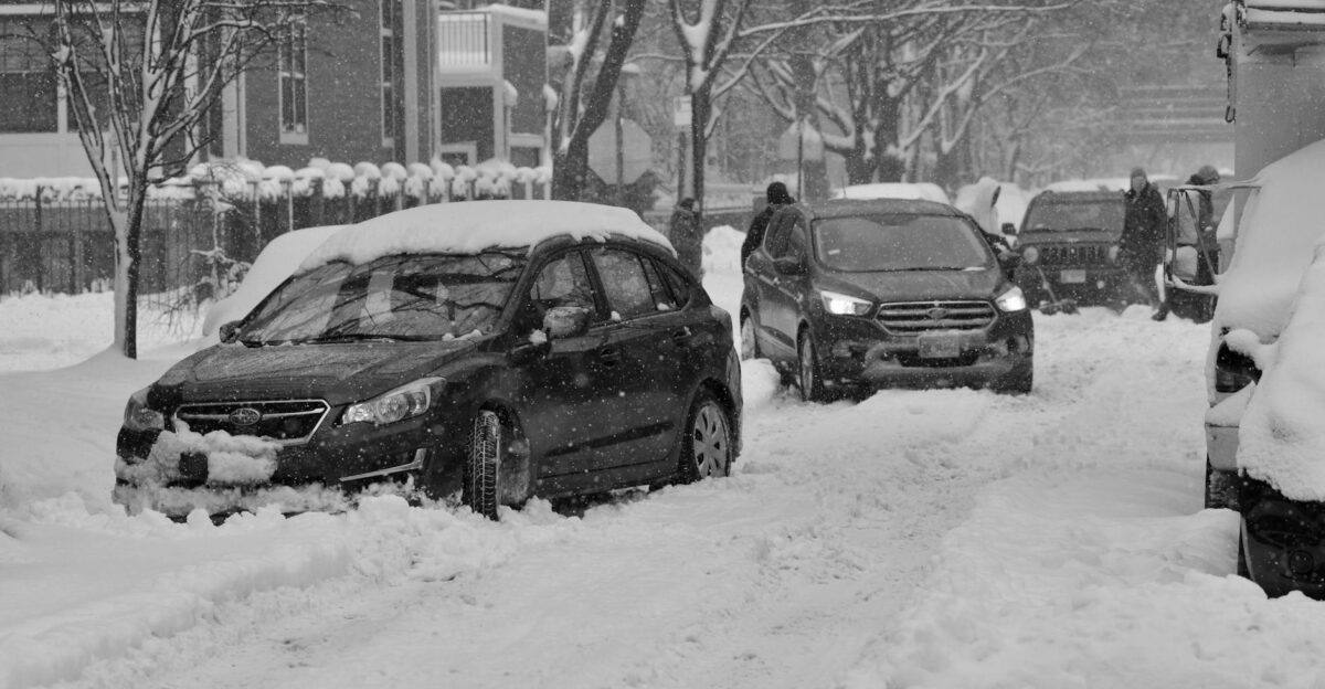 Cars stuck in snow on a snowy Chicago street during winter blizzard