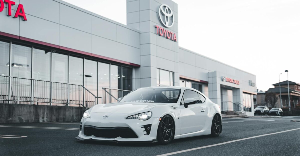 White Toyota sports car parked at a dealership showcasing style and performance