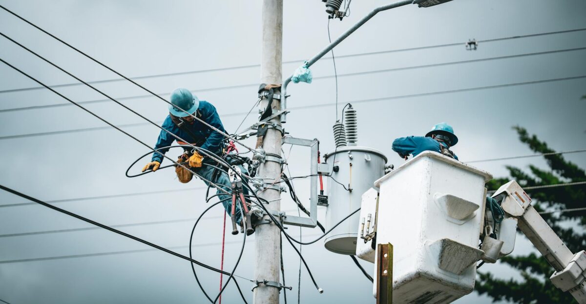 Electricians in San Jos Costa Rica repairing power lines from a cherry picker