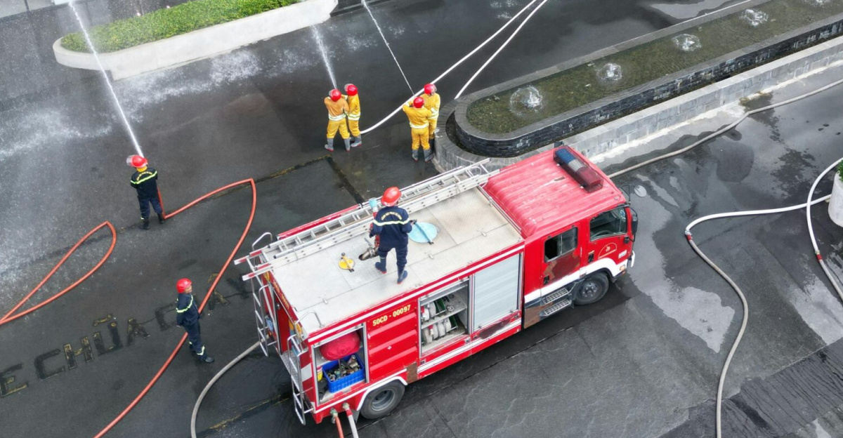 Fire safety drill at CM Tower with firefighters and truck in action.