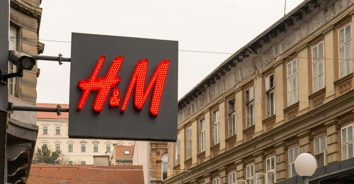 A bustling street in Zagreb, Croatia with people shopping and iconic H&M store in view.
