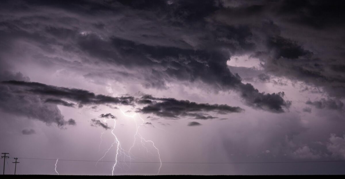Dramatic stormy sky with intense lightning strikes illuminating dark clouds